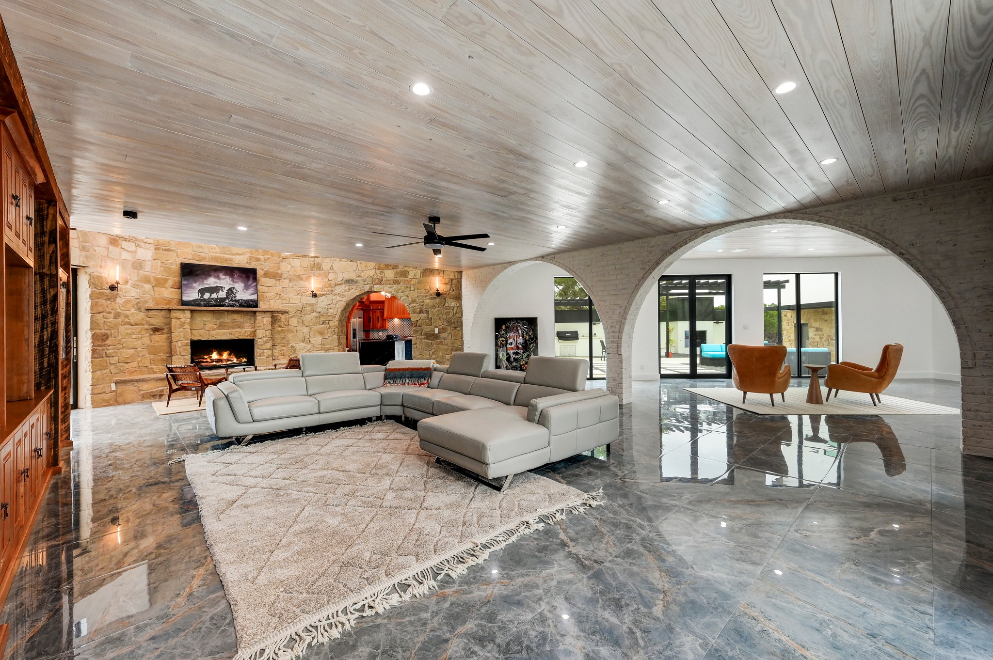 700 Rancho Grande Drive Wimberley, TX 78676 - Photo 7 of 39 Living area featuring arched walkways, wooden ceiling, a stone fireplace