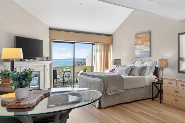 a living room with a bed and a flat screen tv