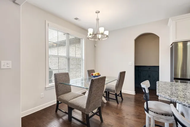 a view of a dining room with furniture wooden floor and chandelier
