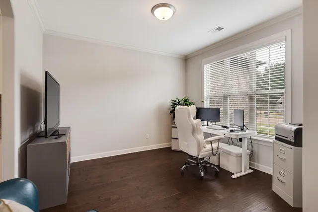 a view of a workspace with furniture and a window