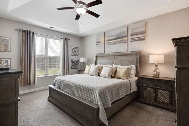 a bedroom with a bed and a window