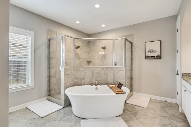 a bathroom with a bathtub and shower