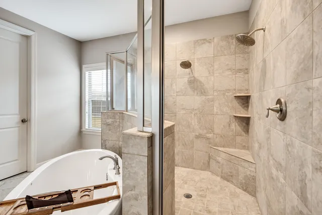 a bathroom with a tub shower and sink