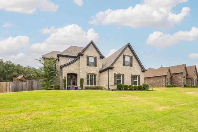 a front view of house with yard and swimming pool