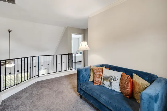 a living room with furniture and a lamp
