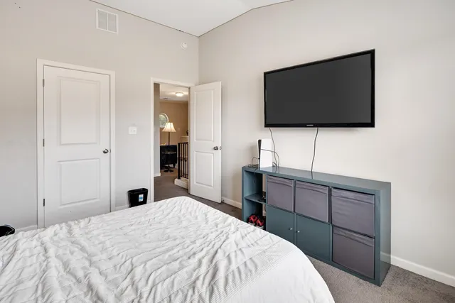 a bedroom with a bed and a flat screen tv