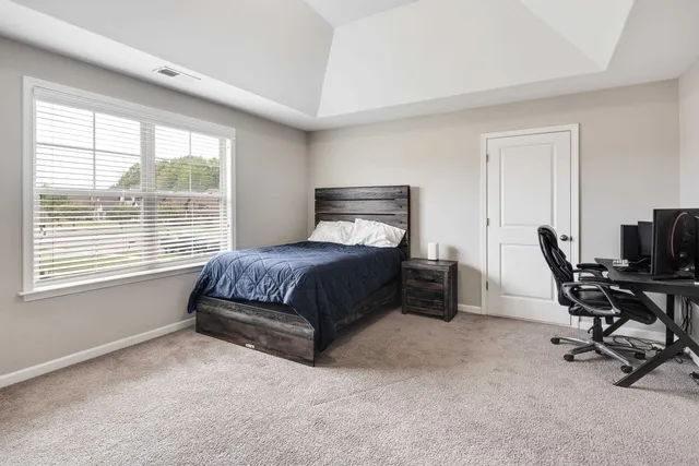 a bedroom with a bed and a desk
