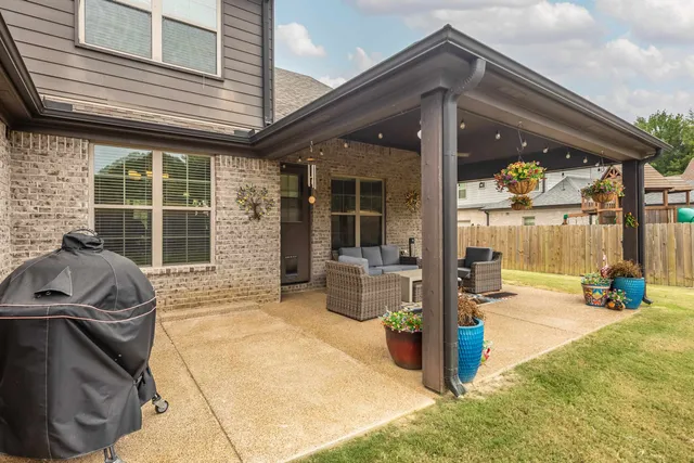 a view of a patio with table and chairs and wooden floor