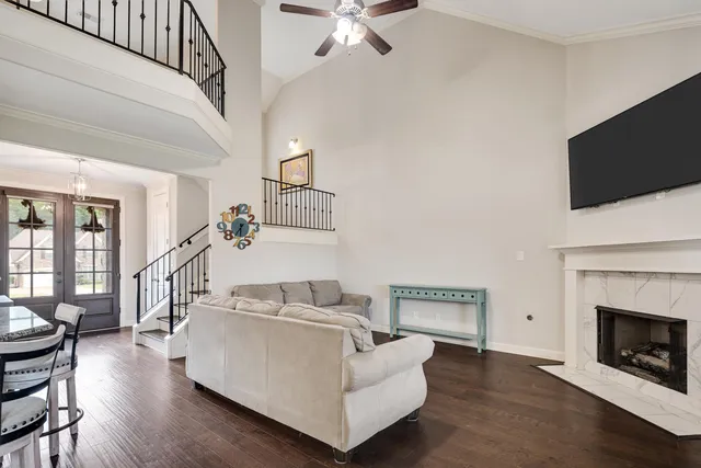 a living room with furniture a fireplace and a flat screen tv