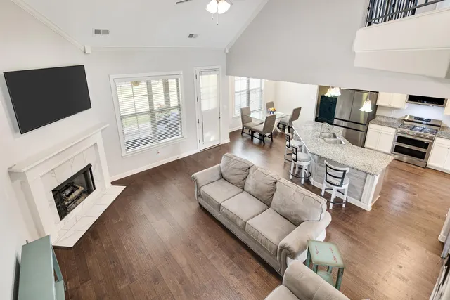 a living room with fireplace furniture and a flat screen tv
