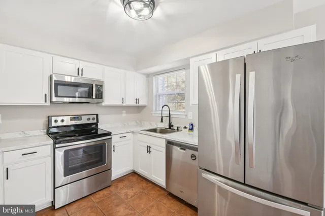a kitchen with a sink stove and refrigerator