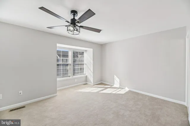 a view of a livingroom with a ceiling fan and window