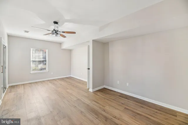 a view of empty room with wooden floor