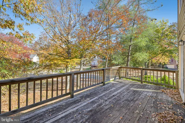 a balcony with wooden floor and trees