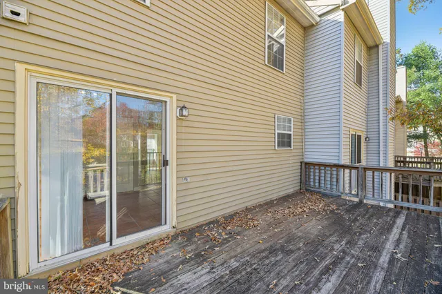 a view of a porch with a door and wooden floor