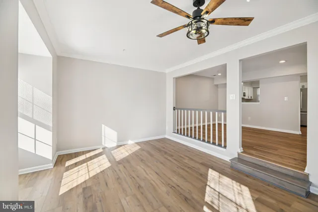 a view of a livingroom with a ceiling fan and window