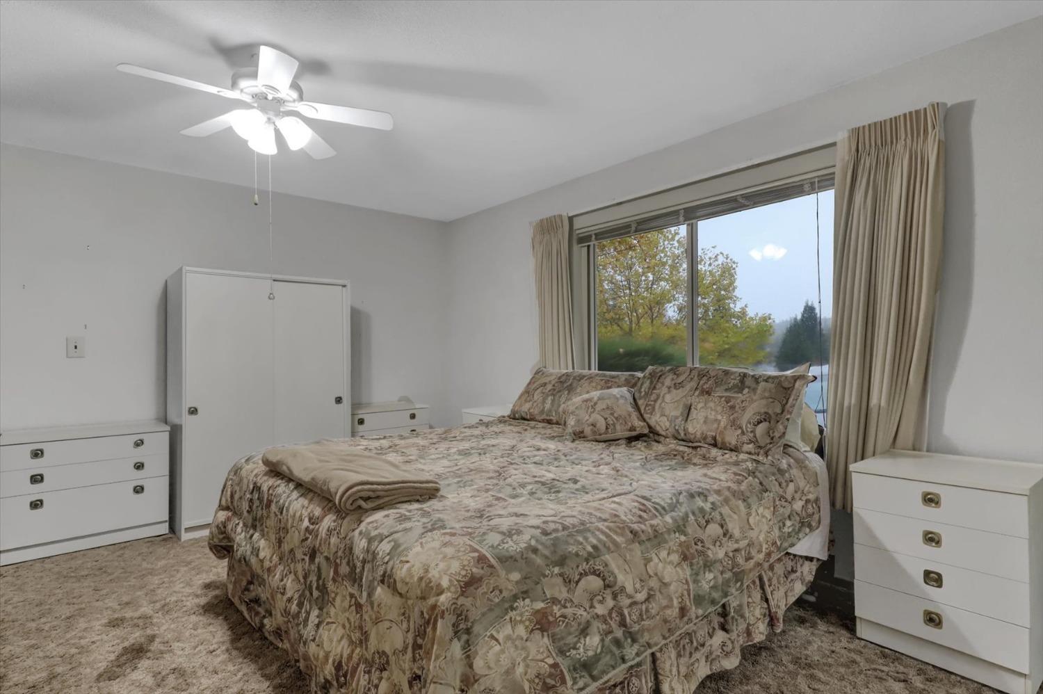 13032 Thistle Loop Penn Valley, CA 95946 - Photo 13 of 30 a bedroom with a large bed and a window