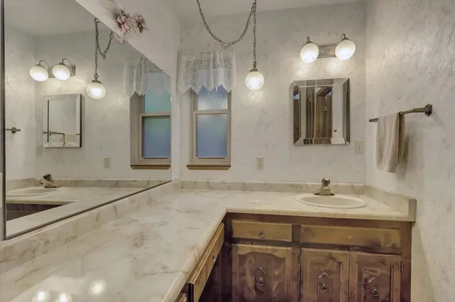 a bathroom with a sink and a mirror