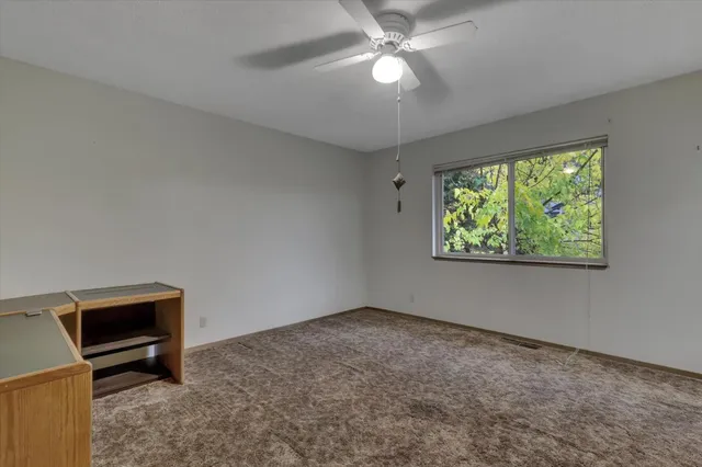en empty room with windows and outdoor view
