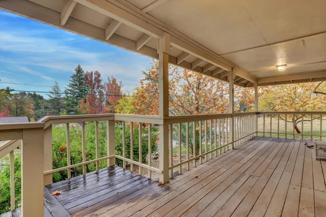 a view of a balcony with wooden floor