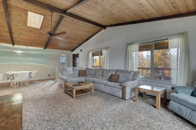 a living room with furniture and a ceiling fan