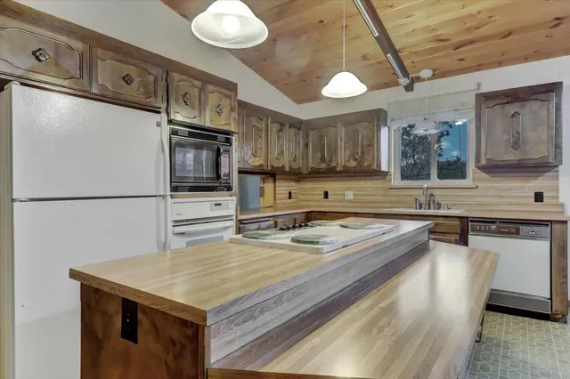 a kitchen with a stove a sink and a refrigerator
