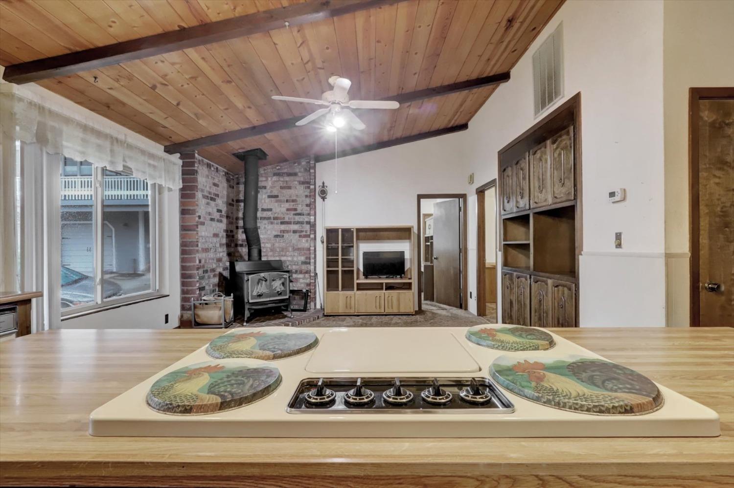 13032 Thistle Loop Penn Valley, CA 95946 - Photo 10 of 30 a view of a livingroom with furniture a fireplace and cabinet