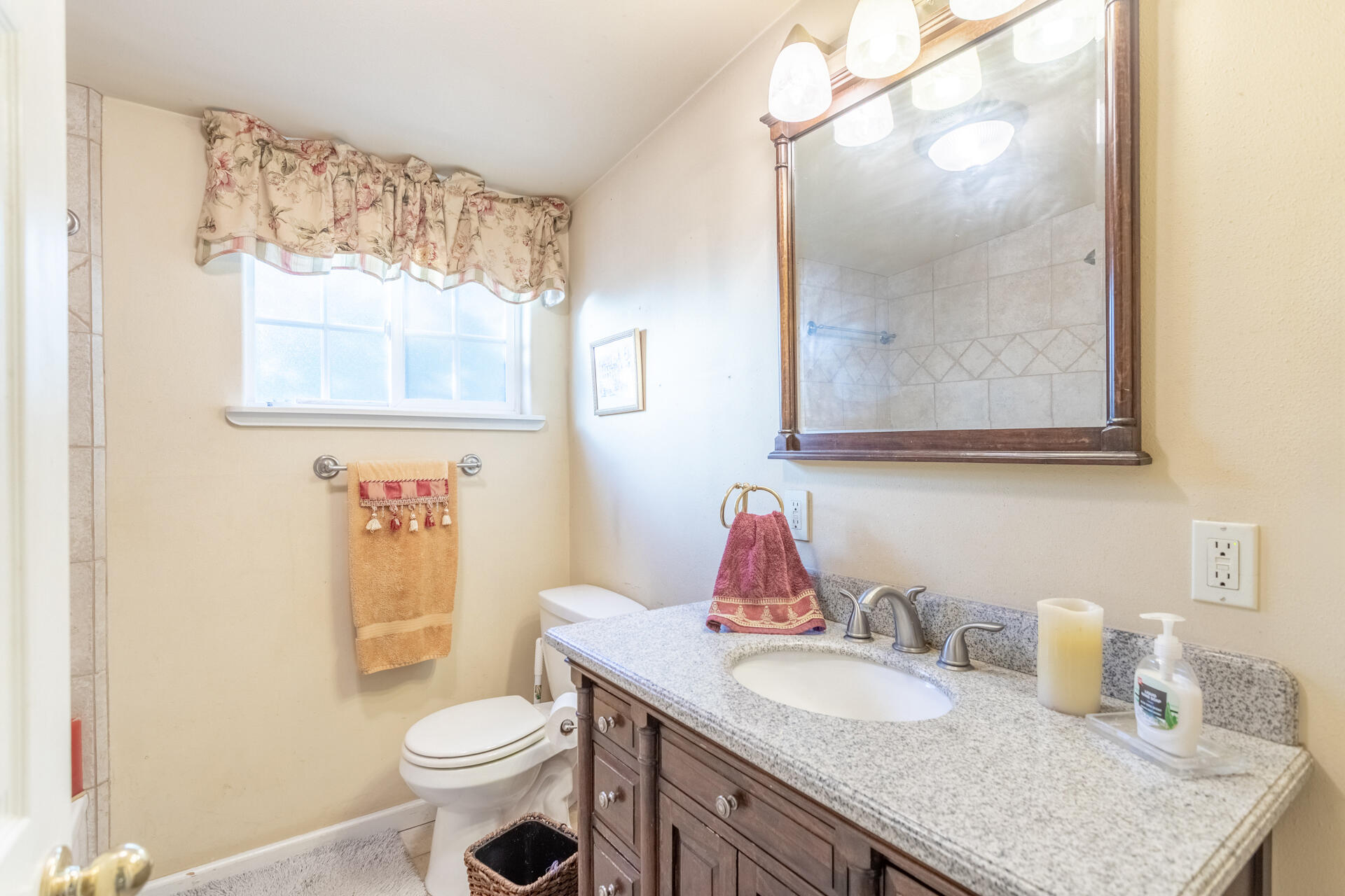 406 South Jackson Street Red Bluff, CA 96080 - Photo 15 of 26 a bathroom with a granite countertop toilet a sink and a mirror