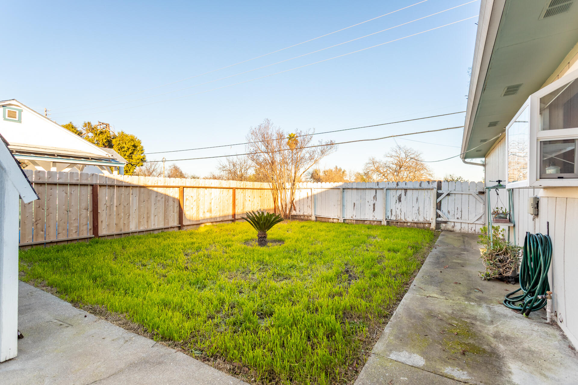 406 South Jackson Street Red Bluff, CA 96080 - Photo 18 of 26 a view of a backyard with wooden fence