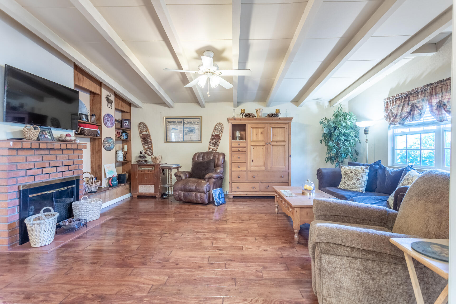 406 South Jackson Street Red Bluff, CA 96080 - Photo 6 of 26 a living room with furniture a fireplace and a flat screen tv