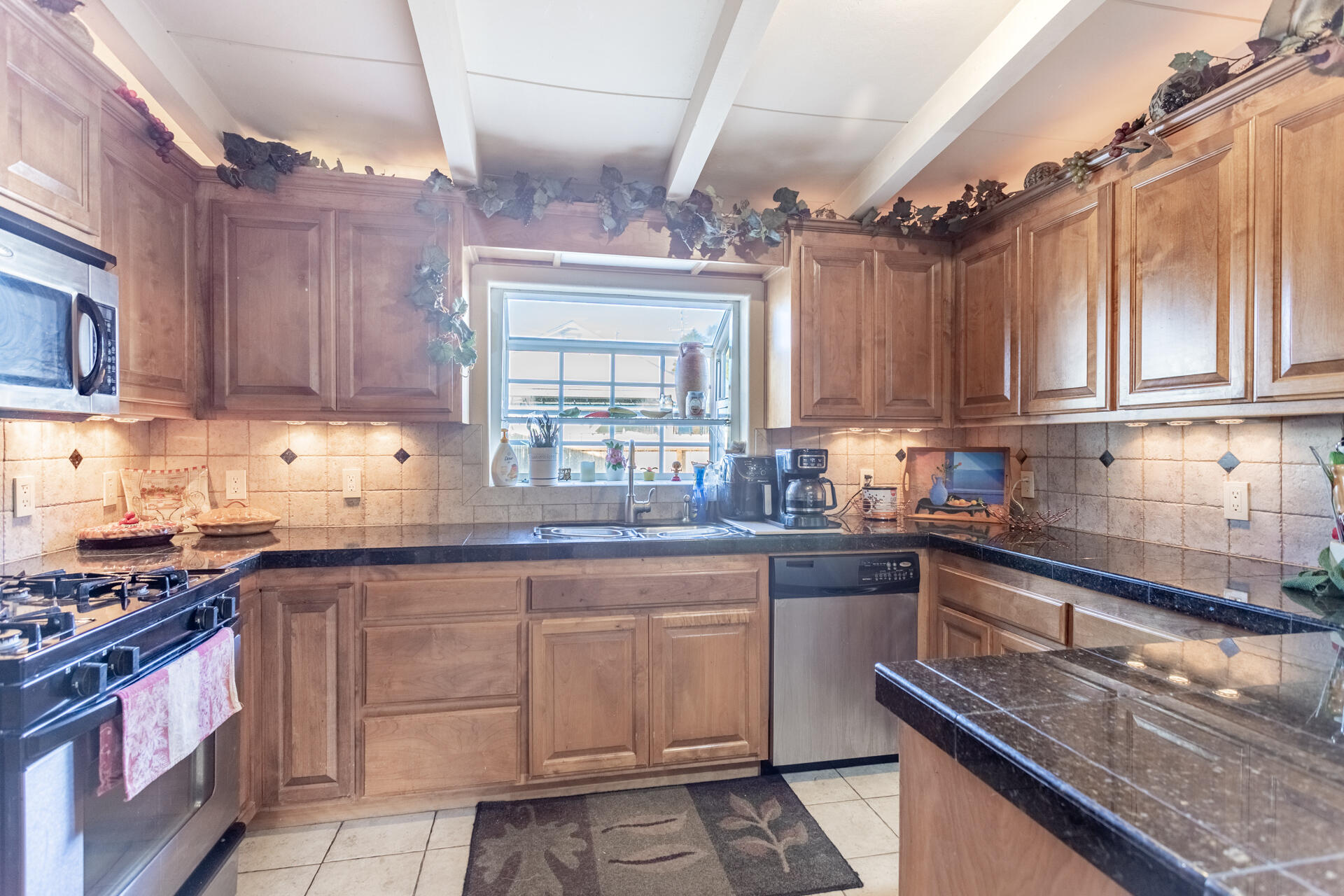 406 South Jackson Street Red Bluff, CA 96080 - Photo 8 of 26 a kitchen with kitchen island granite countertop a sink stove and cabinets