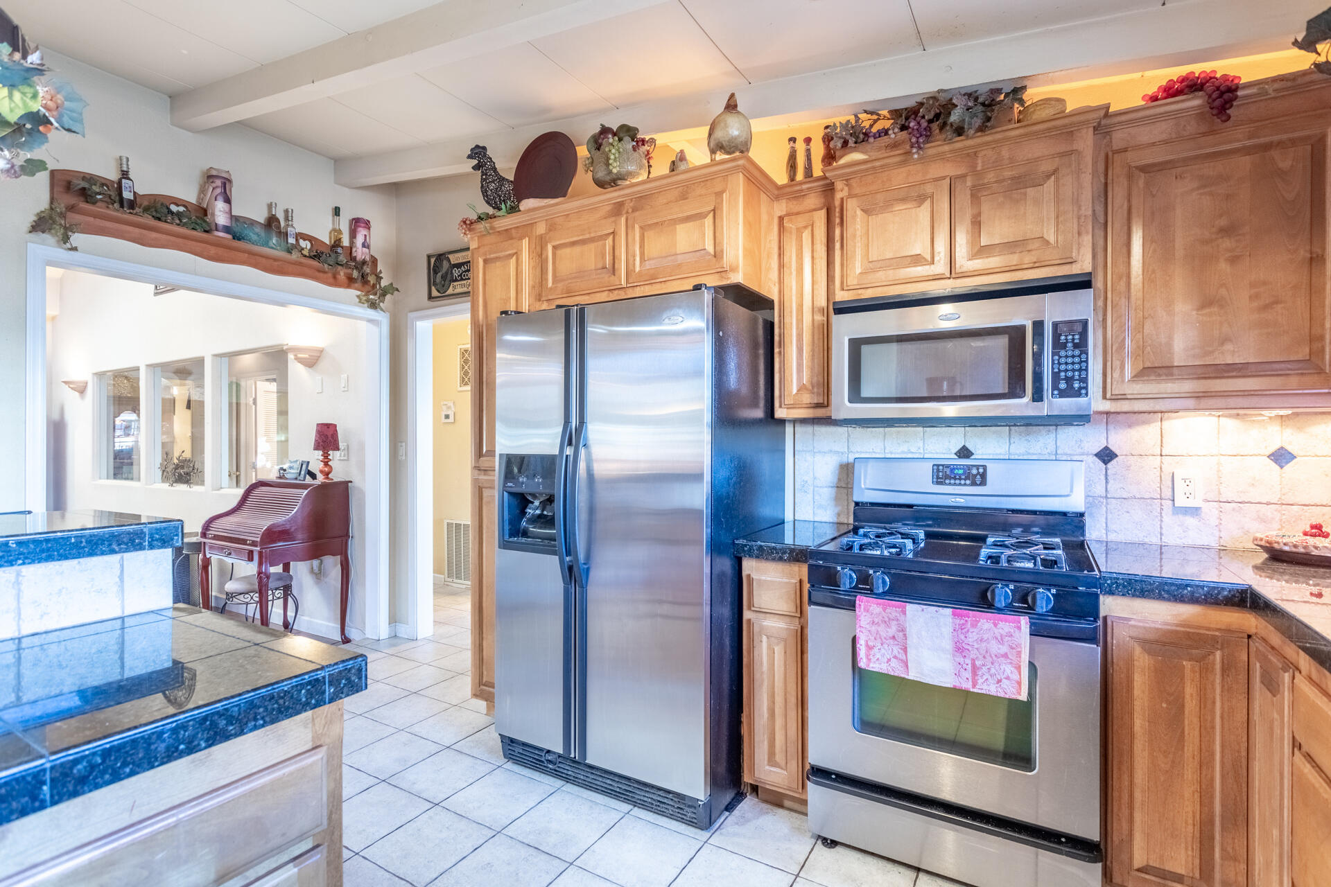 406 South Jackson Street Red Bluff, CA 96080 - Photo 9 of 26 a kitchen with stainless steel appliances granite countertop a refrigerator a stove and a sink with granite countertops