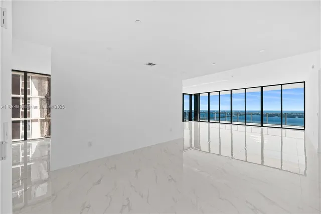 a view of a house with a yard and potted plants