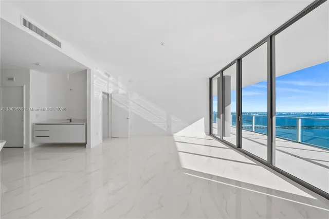 a bedroom with furniture and large windows