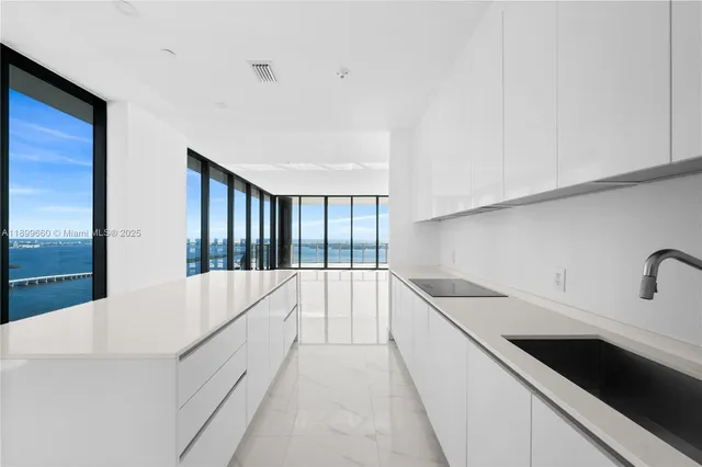 a view of tall house with large windows and potted plants