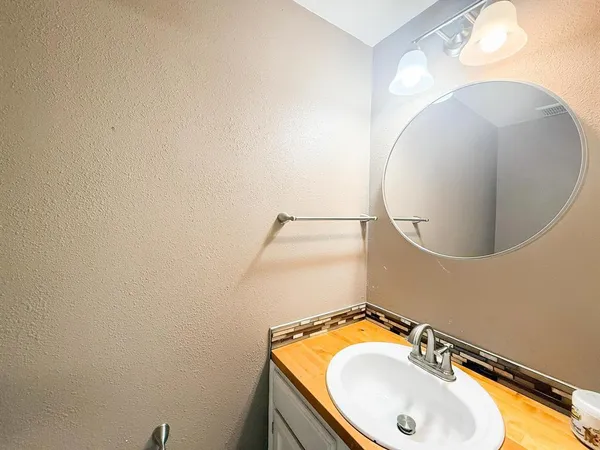 a bathroom with a sink and mirror