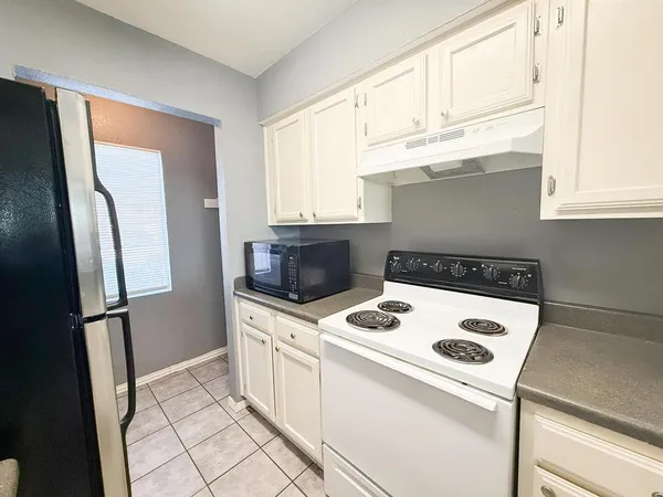 a kitchen with stainless steel appliances a refrigerator a stove a sink and a cabinets