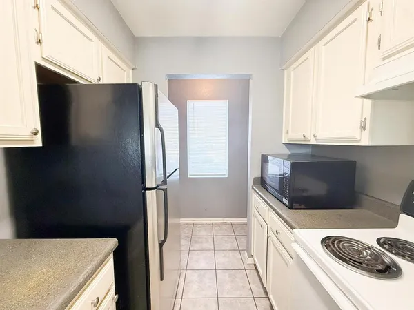 a kitchen with a refrigerator and a sink