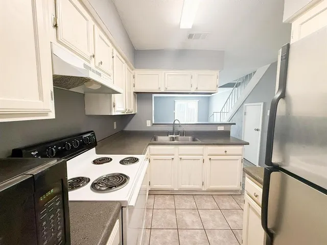 a kitchen with a stove a sink and a refrigerator