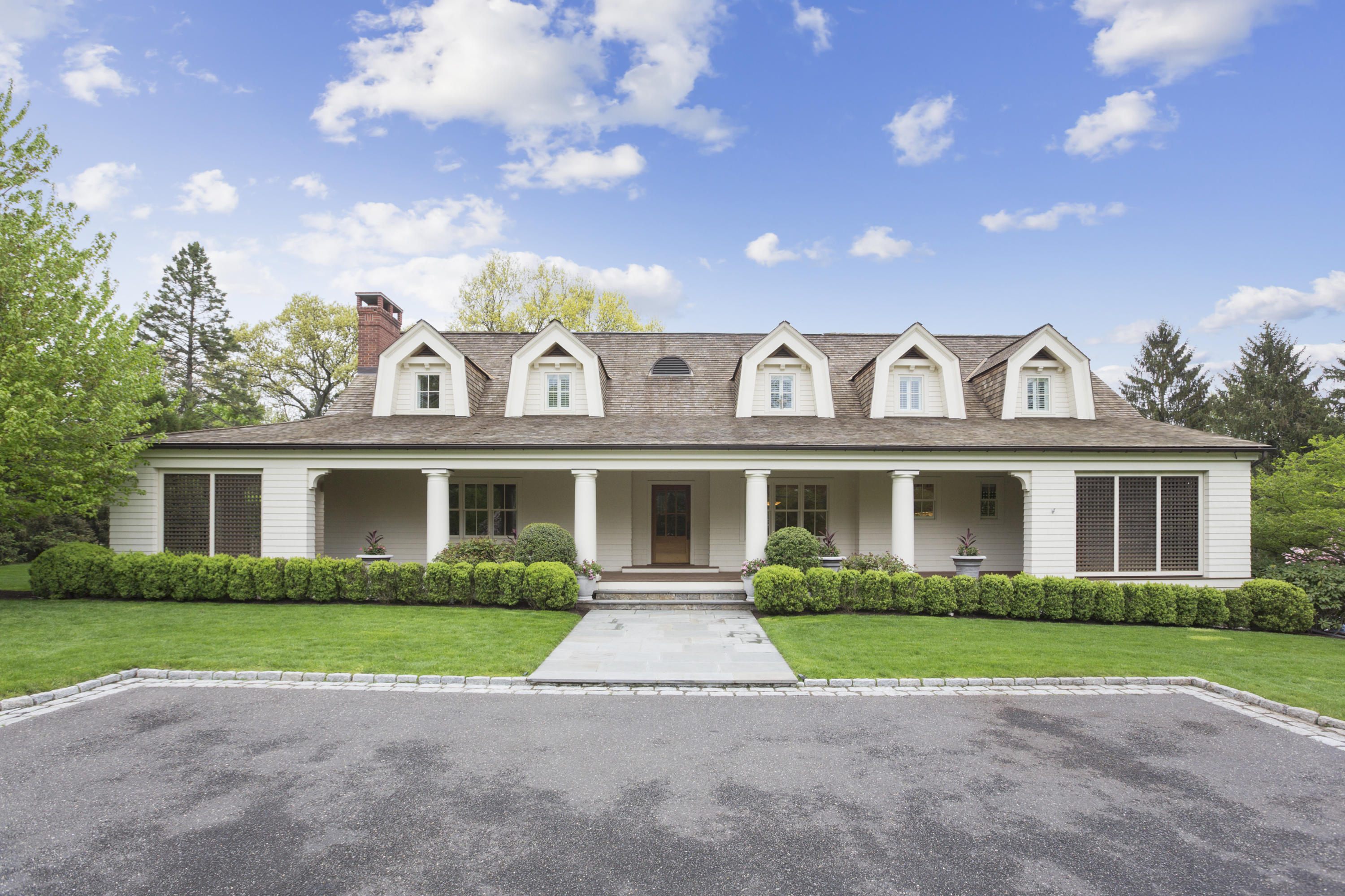 a front view of house with yard and green space