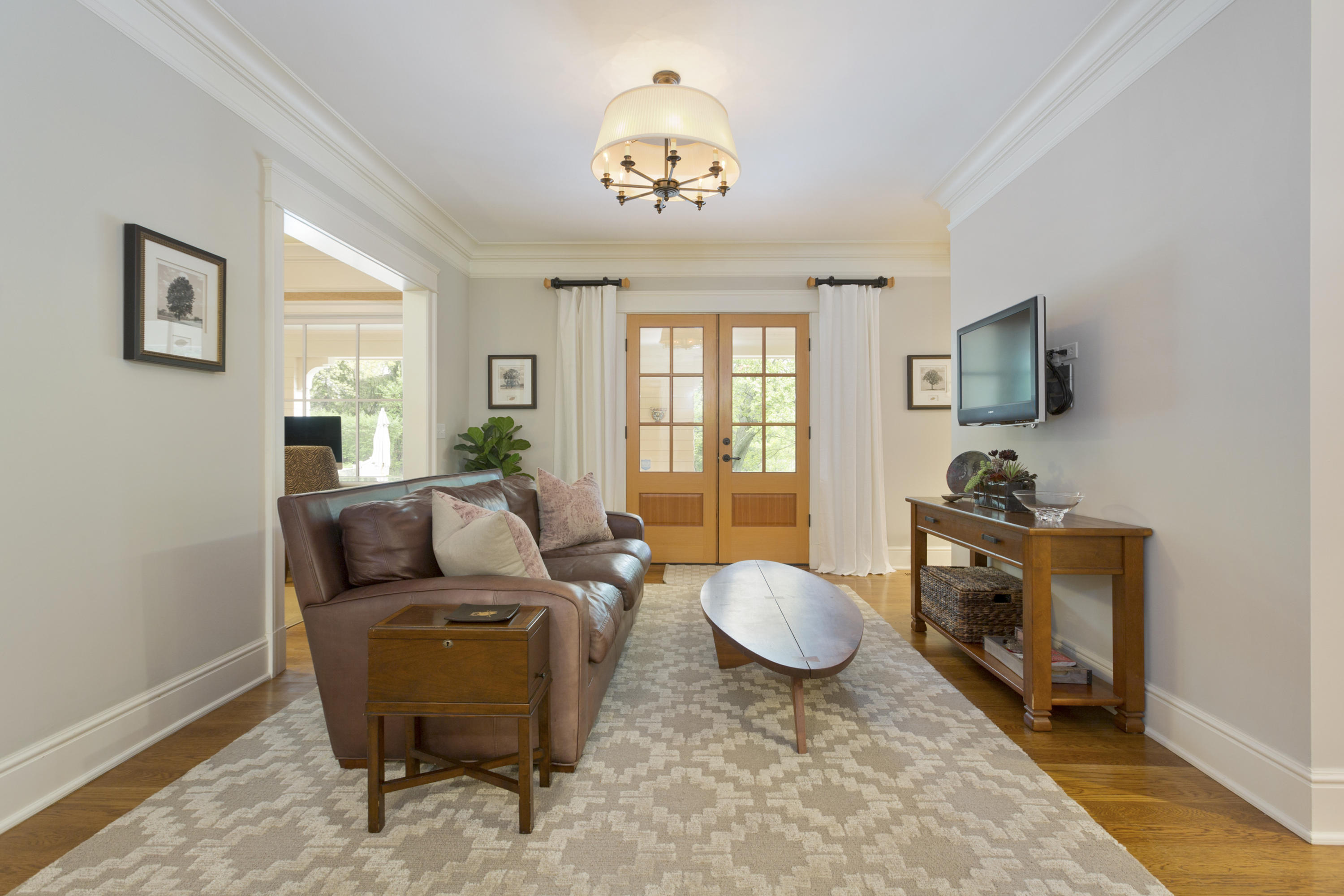 62 Stanton Road Darien, CT 06820 - Photo 17 of 52 a living room with furniture and a chandelier