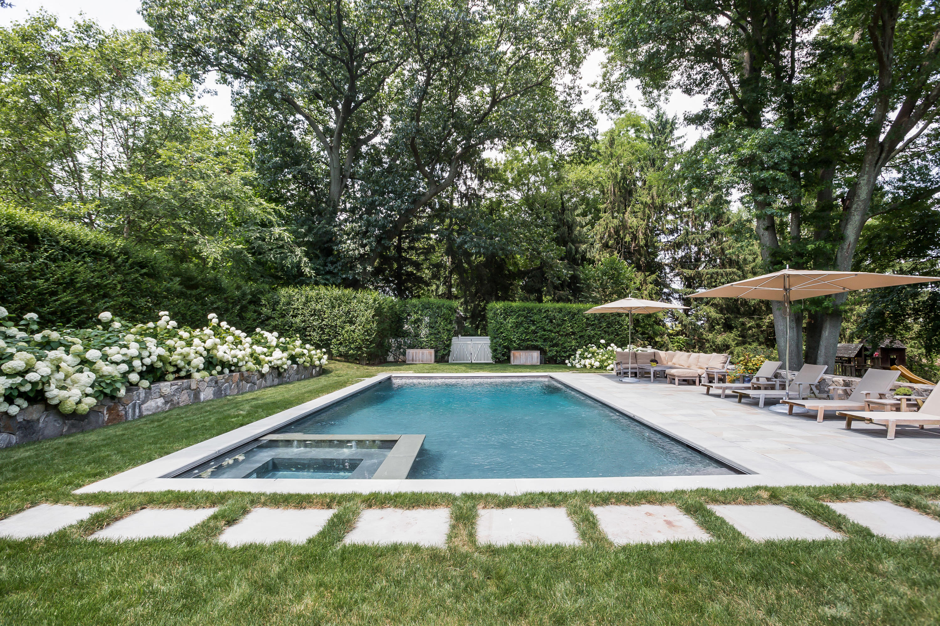 62 Stanton Road Darien, CT 06820 - Photo 43 of 52 a view of a swimming pool with a patio and a garden