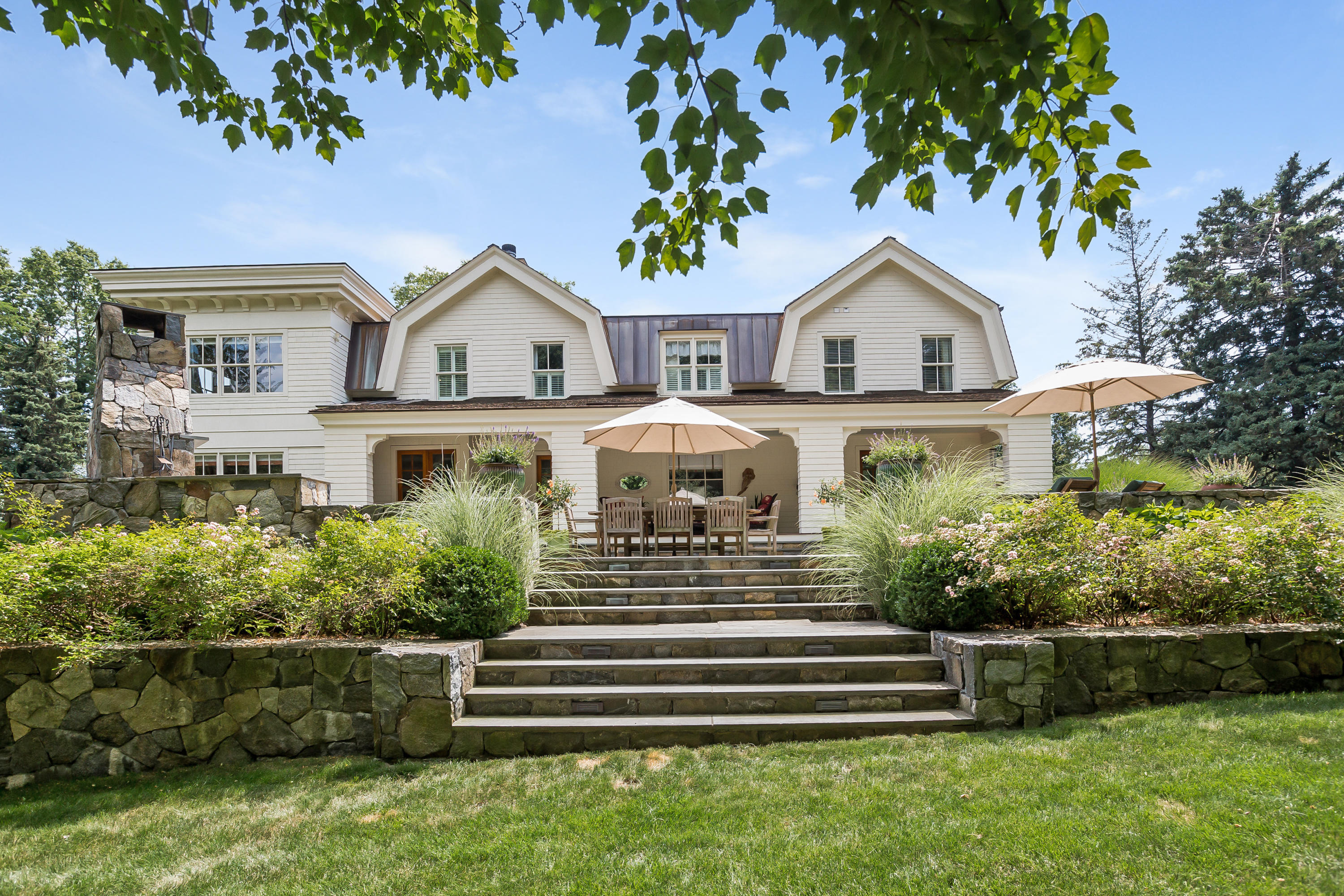 62 Stanton Road Darien, CT 06820 - Photo 46 of 52 a front view of a house with a garden