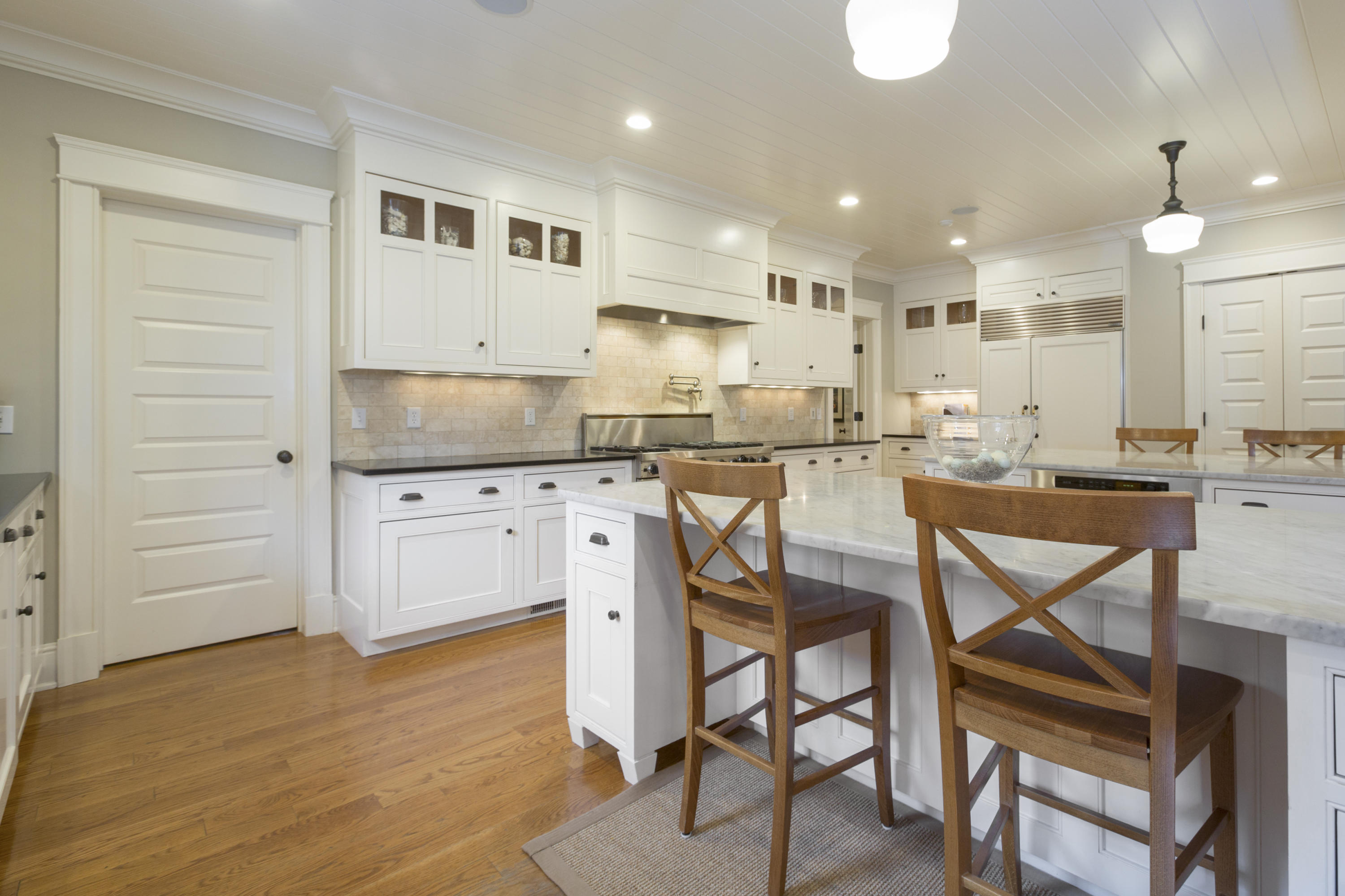 62 Stanton Road Darien, CT 06820 - Photo 10 of 52 a kitchen with stainless steel appliances kitchen island granite countertop a table chairs sink and cabinets