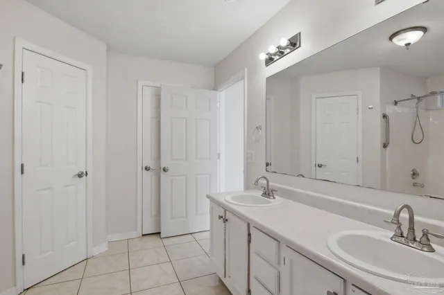a bathroom with a double vanity sink and a mirror