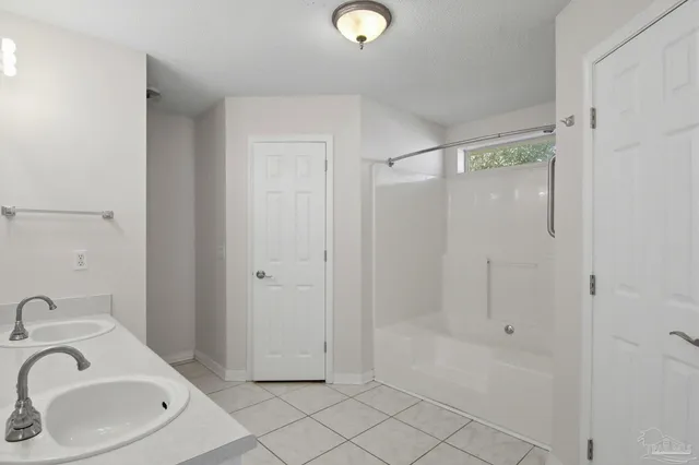 a bathroom with a sink and shower