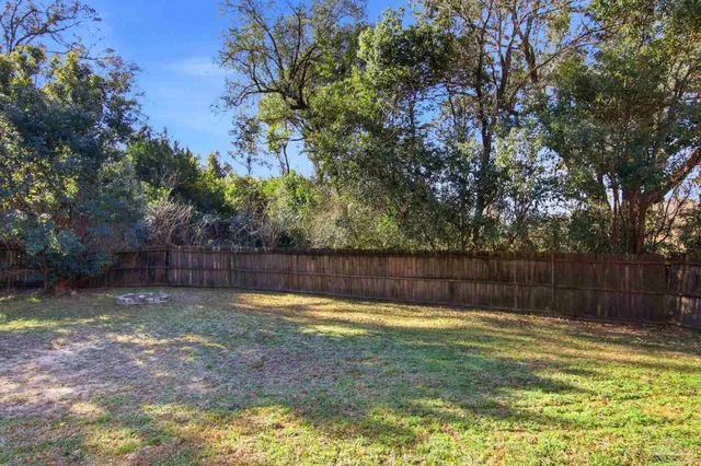 a swimming pool with outdoor seating and yard