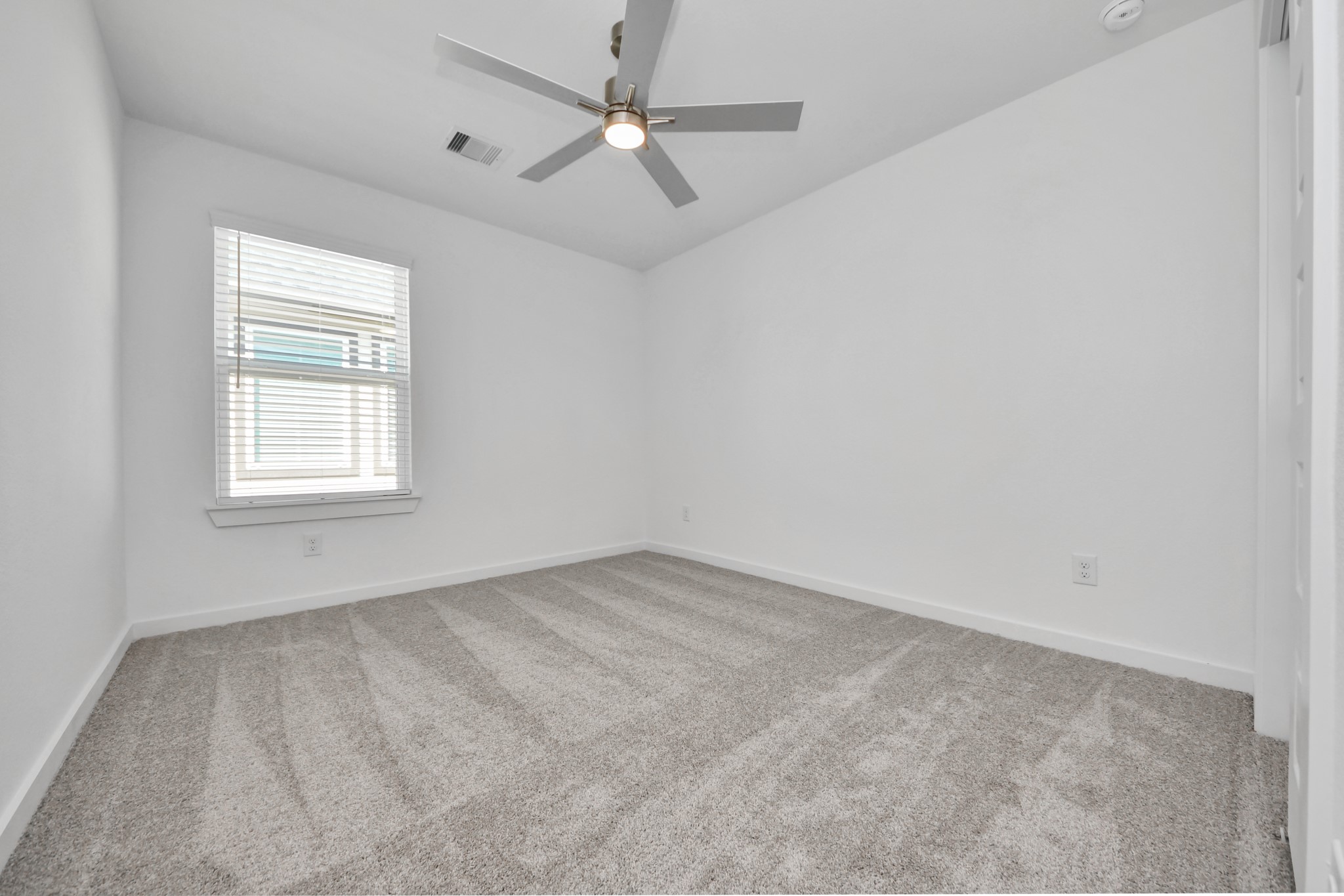 2926 Bury Park Dr Spring Spring, TX 77373 - Photo 31 of 40 Secondary bedroom features plush carpeting, large windows that let in plenty of natural light, bright paint, and spacious closets.