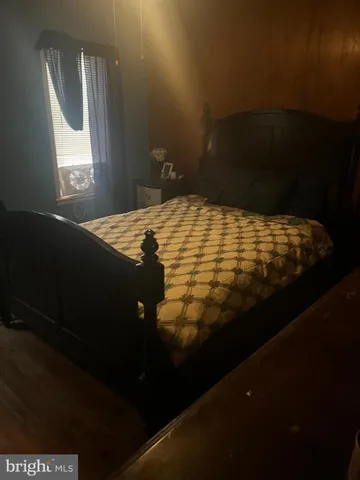 a bed sitting in a bedroom next to a window
