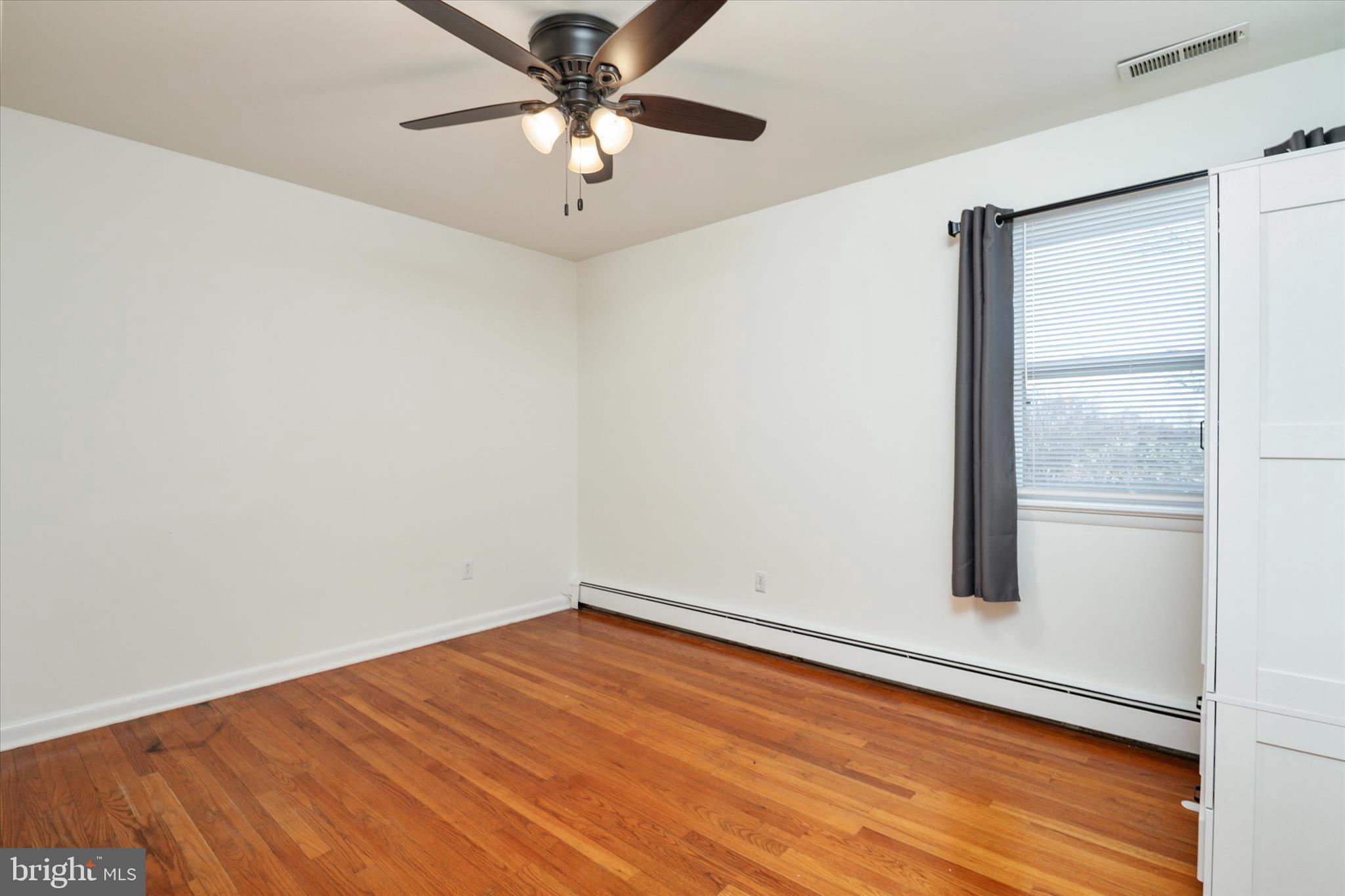 4305 Langrell Road Preston, MD 21655 - Photo 14 of 36 an empty room with a window and wooden floor